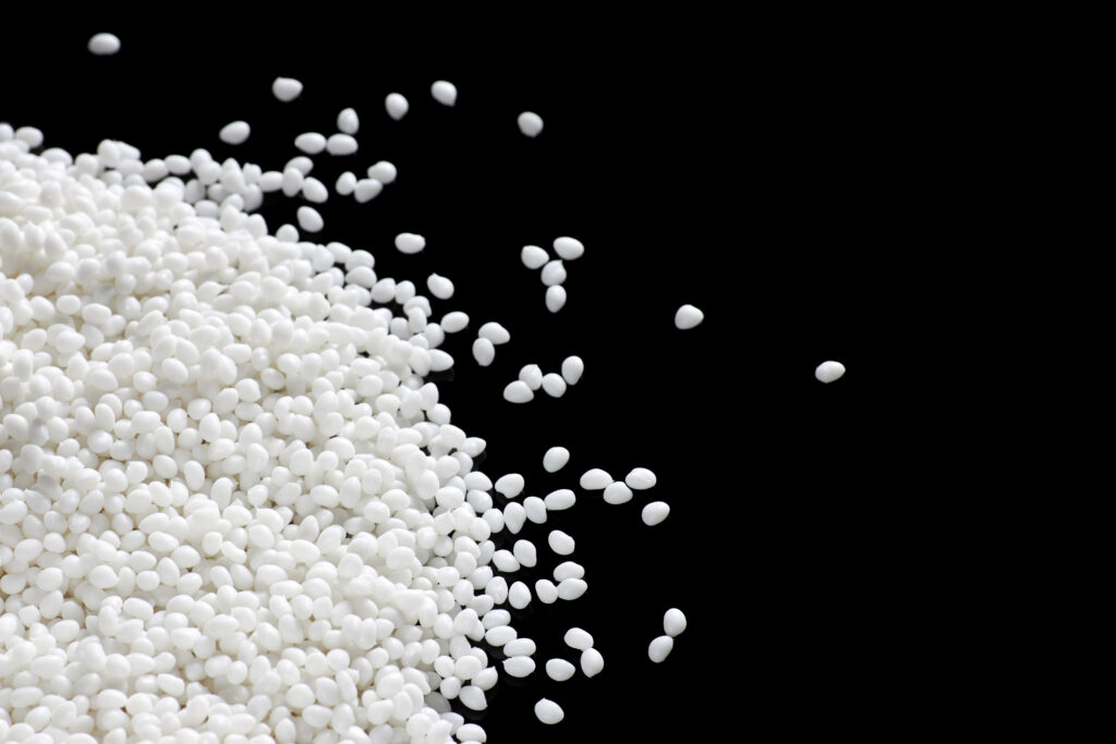 A closeup of a white plastic polymer on a black background. Conceptual image.